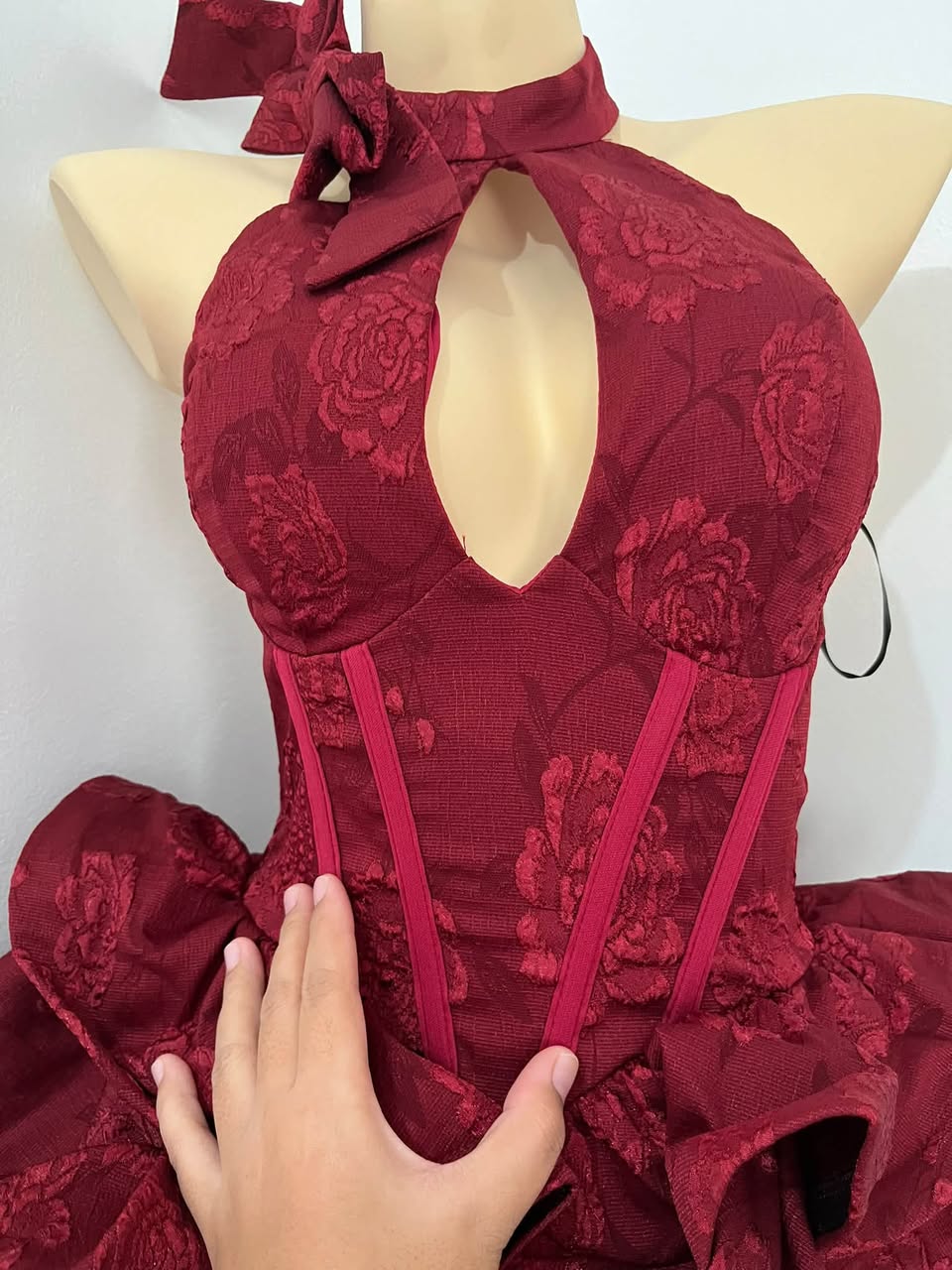 A close look at the bow and floral texture of the Rose dress